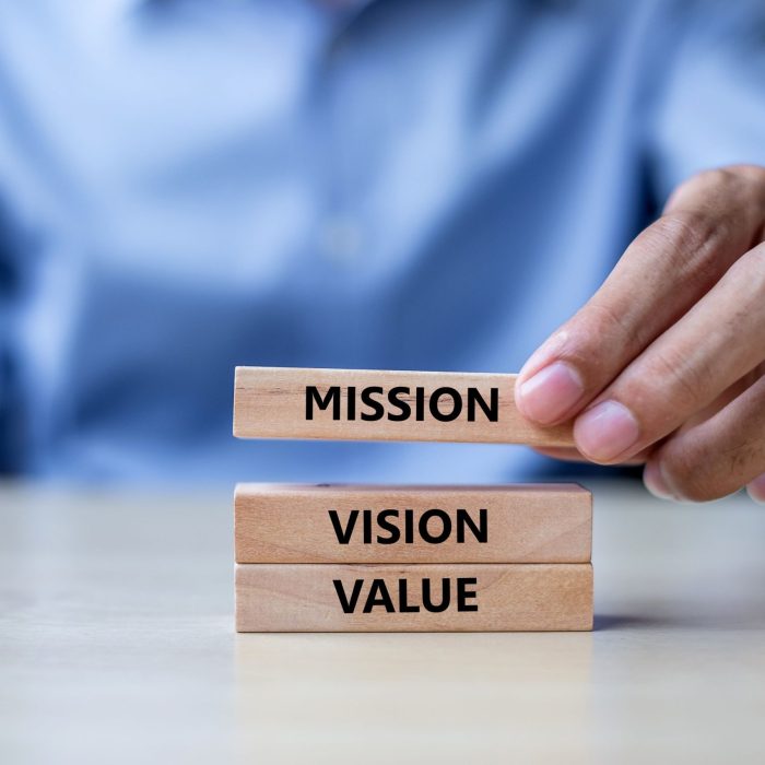 businessman-hand-holding-wooden-building-blocks-on-2021-09-01-09-17-48-utc (1)